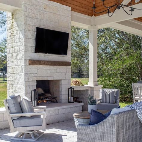 This Patio Retreat Finds Shelter Under a Charming Pergola | HGTV Outdoor Kitchen With Bar, Kitchen With Bar, Grill Patio, Modern Outdoor Fireplace, Outdoor Stone Fireplaces, Covered Outdoor Kitchens, Fireplace Outdoor, Covered Patio Design, Outdoor Sitting