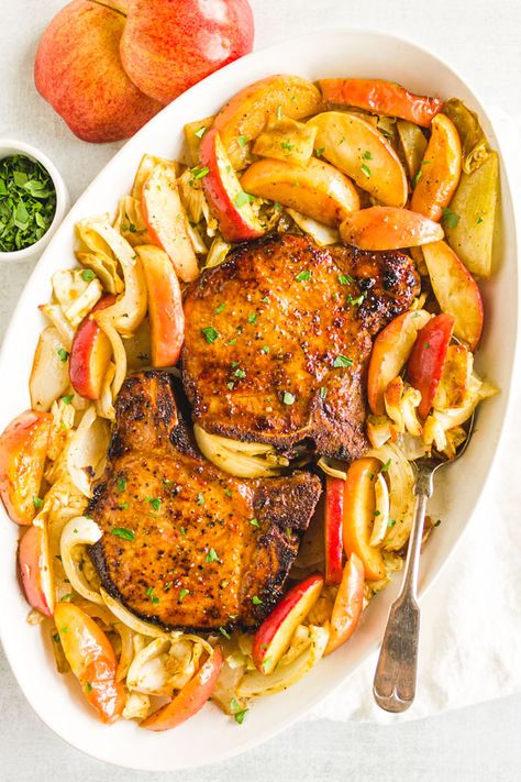 Maple pork chops are roasted on one large sheet pan, along with apples and cabbage for a complete 30 minute meal. The maple marinade keeps the pork chops nice an juicy. A fall time favorite. #30minutemeal #porkchops #fallrecipe #onepanmeal #glutenfreerecipe | robustrecipes.com Oven Pork Chops And Apples, Sheet Pan Pork Chops With Apples, Apple Pork Chop Bake 12 Tomatoes, Sheet Pan Pork Chops With Sweet Potatoes And Apples, Pork Chops Cabbage And Apples, Maple Pork Chops, Pan Pork Chops, Apple Pork Chops, Roasted Apples