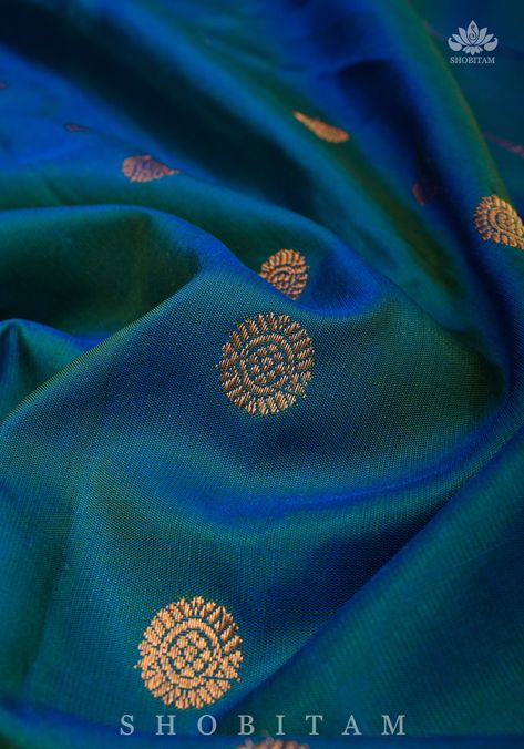 Sure this beautiful Gadwal silk saree takes center stage! Indulge in the richness of this prized weave, authentic Handwoven Gadwal Silk Sarees make an excellent choice for special occasions. It comes in a dual tone blue green with coin zari motifs in the body with Meenakari Border. This saree comes with an unstitched blouse fabric and is ready to wear with fall and pico complete. Handmade tassels line the pallu.SILK MARK CERTIFIEDNote: There may be a slight difference in shade between the actual Peacock Blue Saree, Meenakari Saree, Gadwal Silk Sarees, Sea Blue Color, Blue Silk Saree, New Blouse Designs, Peacock Color, Simple Blouse Designs, Simple Blouse