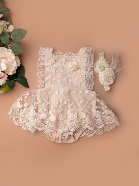 Our lace beige/champagne boho rompers are super soft and comfortable. This cotton and lace romper is adorned with feathers and flowers. The lace band ties around the waist and unties- easy for diaper change. The combination of lace, feathers, flowers and rhinestone is perfect to be worn for birthday parties, cake smash sessions, baby showers, weddings or for your little girl to dress up during playtime.  Headband:  Over the top headband with feathers, rhinestones and French net. A must have to match the romper!   SizeLengthHipsWaistRecommended Age 6M     43.5 cm60 cm43 cm0-6 months 9M     45 cm64 cm45 cm6-9 months 12M     46 cm68 cm47 cm9-12 months 18M     48 cm72 cm47 cm12-18 months 24M     49.5 cm76 cm51 cm18-24 months Cute Cream Dress For First Birthday, Baby Wedding Outfit Girl 6 Months, First Birthday Fitted Sets With Ruffles, First Birthday Cotton Romper With Ruffles, Flower Girl Outfit, First Birthday Outfit Girl, First Birthday Dresses, Boho Romper, Baby Girl Floral Romper