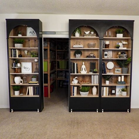 Black painted Ikea Billy bookcase filled with books and other objects opened to show storage space behind. Bookcase Door Diy, Ikea Entertainment Center, Ikea Decor Hacks, Billy Bookcase With Doors, Ikea Billy Hack, Living Room Hacks, Billy Ikea, Ikea Organization Hacks, Ikea Desk Hack