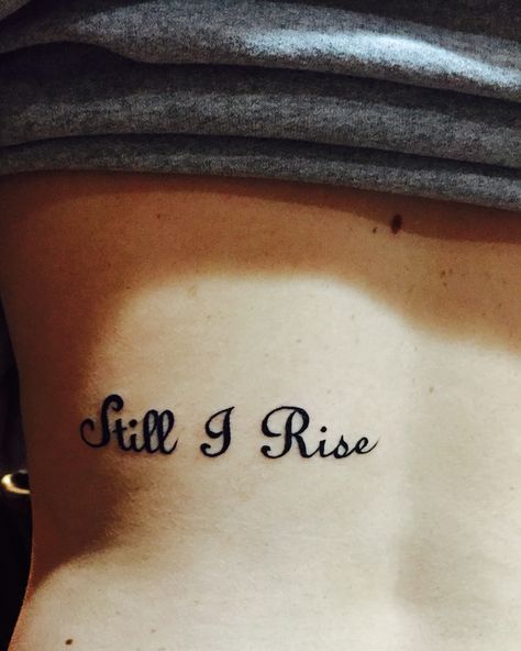 Still I Rise tattoo on mid back inspired by the late Maya Angelou #still #i #rise #tattoo #mayaangelou #Angelou #maya #back Carrie Tattoo, Angelou Maya, Purple Ribbon Tattoos, I Rise Tattoo, Jewelry Sayings, Simple Unique Tattoos, Still I Rise Tattoo, Rise Tattoo, Freedom Tattoo