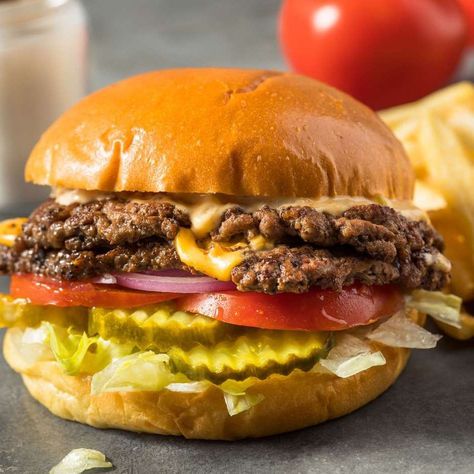 What is a smash burger and why is the dish popping up on menus all over? Learn what makes this type of burger so irresistible and how you can make them at home. Smash Burger Recipe, Smash Burgers, Entertaining Dinner, Michael Symon, Pickle Butter, Grilled Burgers, Homemade Burgers, Smash Burger, Delicious Burgers