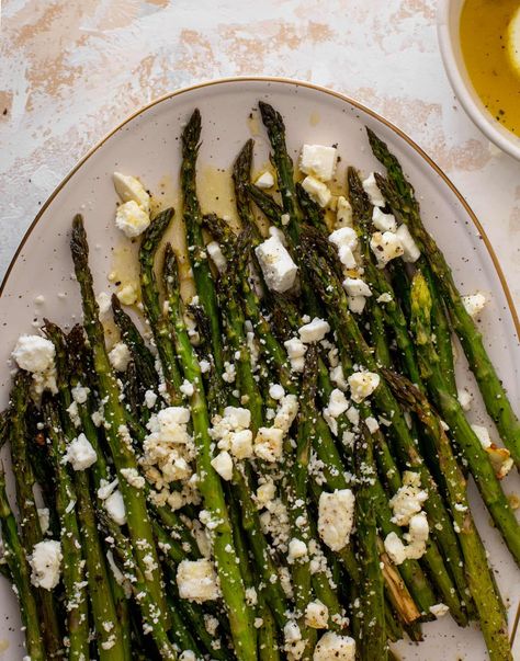 This roasted asparagus is the perfect easy side dish for a holiday meal or a simple weeknight dinner. Drizzled with lemon vinaigrette and topped with crumbled feta, it’s full of flavor and comes together super fast! Easy Asparagus Recipes, Asparagus Recipes Roasted, Feta Recipes, Easy Side Dish, Lemon Vinaigrette, Dinner Side Dishes, Holiday Side Dishes, Holiday Meal, Roasted Asparagus