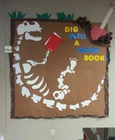 Bulletin Board Idea: "Dig Up a Good Book" Kids love dinosaurs so ... Dinosaurs Classroom Decorations, Dinosaur Door Decorations Classroom, Dinosaur Classroom Theme Decor, Dinosaur Classroom Theme, Dinosaur Bulletin Boards, Book Bulletin Board, Dino Decor, School Library Bulletin Boards, Dinosaur Display