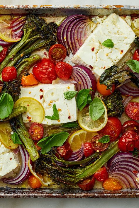 NYT Cooking: When baked, feta gains an almost creamy texture, similar to goat cheese but with feta’s characteristic tang. In this easy vegetarian sheet-pan dinner, broccolini (or broccoli), grape tomatoes and lemon slices roast alongside the feta until the broccolini crisp, the tomatoes burst and the lemon rinds soften. (Remember, broccolini has a tender, delicious stalk so only the bottom 1/2-inch needs to... Roasted Feta Veggies, Baked Feta With Vegetables, Chicken Feta Broccoli Sheet Pan, Summer Vegan Recipes Dinner, Sheet Pan Dinners Vegetarian, Sheet Pan Feta, Vegetarian Sheet Pan Dinners, Mediterranean Sheet Pan Dinners, Crisp Gnocchi