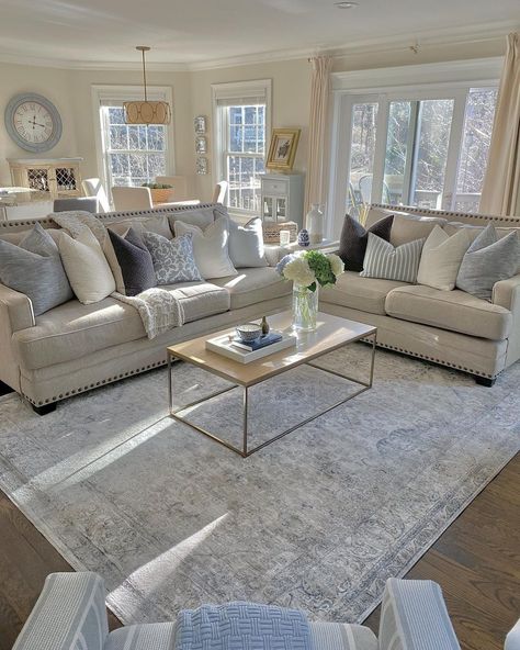 This farmhouse living room boasts a modern light wood and nickel coffee table for beige couch on top of a gray vintage rug. The couch is paired with a matching love seat adorned in light blue and white throw pillows. Light Blue Living Room, Light Gray Couch, Princess Home, Beige Couch, House Chores, Beige Living Rooms, Coastal Home Decor, Modern Farmhouse Living Room, Farmhouse Living Room