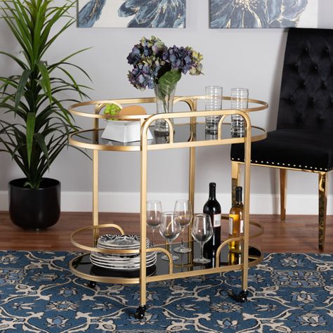 Everly Quinn Olympie Baxton Metal and Tempered Glass 2-Tier Bar Cart | Wayfair Raised Borders, Shaped Shelves, Affordable Dining Room Sets, Wine Cart, Metal Bar Cart, Gold Bar Cart, Contemporary Glam, Tempered Glass Shelves, Caster Wheels