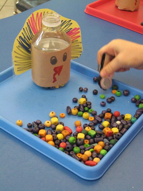 I came up with this idea on a whim when thinking of a way to get my preschoolers to move items one at a time with tongs or tweezers.  I decorated a small water bottle to look like a turkey and gave them beads and a strawberry picker.  Just challenging enough for them to pick up and "FEED THE TURKEY."  I think I will do the same with Santa and have the kids feed him "Cookies."  - repinned by @PediaStaff – Please Visit  ht.ly/63sNt for all our ped therapy, school & special ed pins Feed The Turkey, Turkey Activity, Thanksgiving Lessons, Thanksgiving School, November Activities, Thanksgiving Preschool, Preschool Fine Motor, Small Water Bottle, Fall Preschool