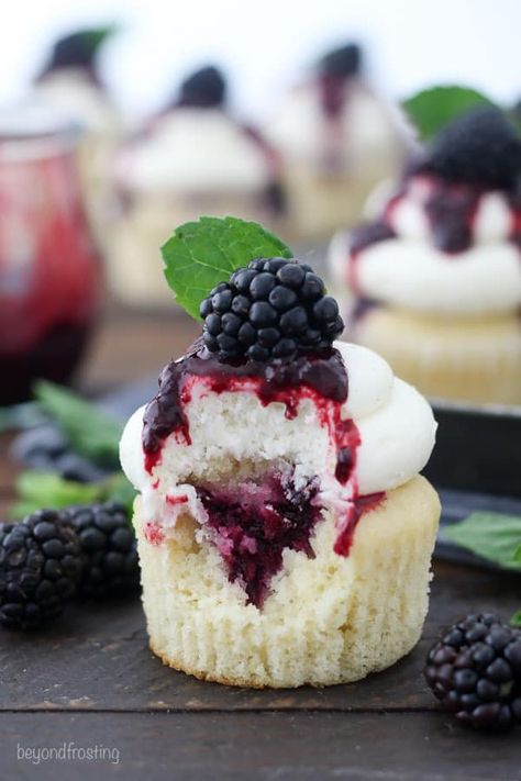 These Blackberry Bourbon Smash Cupcakes are vanilla bourbon cupcakes with a blackberry mint infused filling and topped with a vanilla bean buttercream. #cupcakes #blackberry #blackberrycupcakes #bourbon #bourboncupcakes #blackberrybourbon #homemadecupcakes Vanilla Cupcake With Filling, Berry Filled Cupcakes, Cupcakes With Fruit On Top, Fruit Filled Cupcakes, Blackberry Bourbon Smash, Bourbon Cupcakes, Cupcakes Rellenos, Boozy Cakes, Blackberry Cupcakes