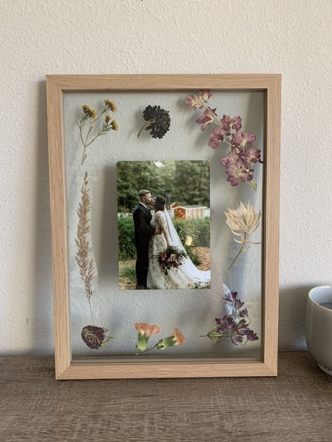 Dried wedding flowers in a wooden press for 2 months and then framed them with a wedding photo Photo Display Gift Ideas, Flowers In Picture Frames Diy, Flowers Pressed In Frame, Pressed Flowers Framed With Picture, Flowers In Photo Frame, Photo Frame Flowers, Dried Flowers In Photo Frame, Picture Frame With Dried Flowers, Dry Flower In Frame