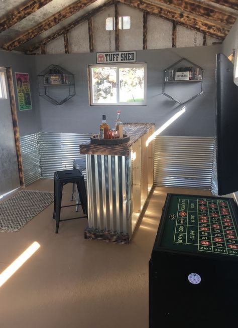 A man cave can be as simple or as decked out as you'd like. This rustic, welcoming Man Cave shed has plenty of space for hosting parties and game nights, without taking up too much space in the backyard. With rustic galvanized steel and wood accents, a fully stocked bar, flatscreen TV, and plenty of room to move around, your guests won't believe that your man cave is inside a Tuff Shed building. From shed to man cave-DIY! Simple Man Cave Ideas, Party Shed Ideas, Tiny Man Cave, Backyard Mancave, Backyard Shed Man Cave, Backyard Man Cave Sheds, Man Shed Interior Ideas, Man Cave Shed Ideas, Man Cave Loft