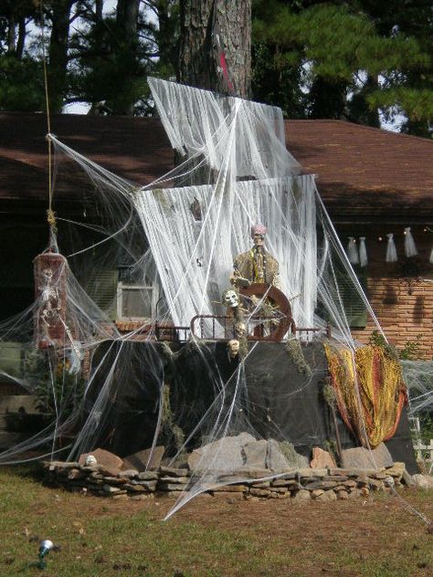 My Daughter is the Halloween Queen on our street. She goes all out every year. Each year she try to out do the year before by adding something new. This year it was the Ghost Pirate Ship. The cool thing about it all is that she has only spent about $10.00 dollars this year for the webbing. Her Aunt next Door had a new roof put on this summer and that where she got everything to build her ship (left over’s from the Roofers) Wonderful Job Bran-! Looks Great!! Ghost Pirate Ship, Pirate Halloween Decorations, Ghost Pirate, Pirate Halloween Party, Halloween Outside, Pirate Decor, Pirate Halloween, Halloween Queen, Halloween 2014