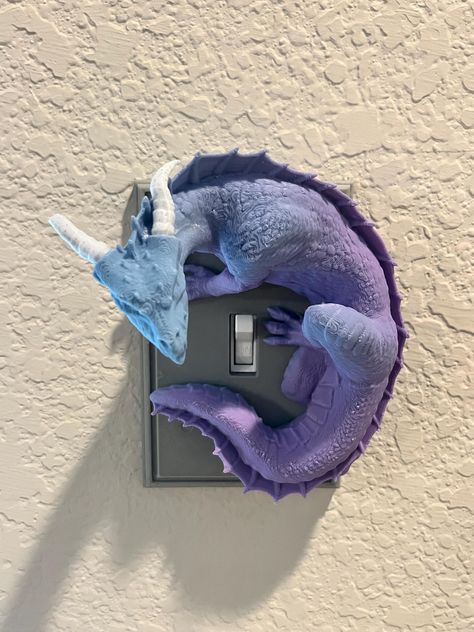 Unleash the magic in your home with our Enchanted Dragon Light Switch Cover! Crafted with precision using durable PLA plastic, this captivating cover is designed to look like a damaged stone wall, with a majestic 3D dragon elegantly circling your light switch. It's the perfect way to add a touch of fantasy to any room! 🌟 Features: Magical Design: The detailed dragon and weathered stone wall bring a mystical ambiance to your space. Easy Installation: Fits standard light switches, making it a breeze to transform your room. comes in 1 or 2 light switch options. Screw on the face plate then snap on dragons. Unique Gift: Ideal for fantasy lovers, dragon enthusiasts, or anyone looking to add a bit of enchantment to their home decor. Colors: 1 and 2 Gang Switch covers come standard gray, 1 Gang Fantasy Inspired Room Decor, Dragon Wall Decor, Fantasy Room Decor Ideas, Fantasy Room Decor Diy, Dragon Room Decor, Nerd Home Decor, Wizards And Dragons, Fantasy Room Decor, Dragon Bedroom