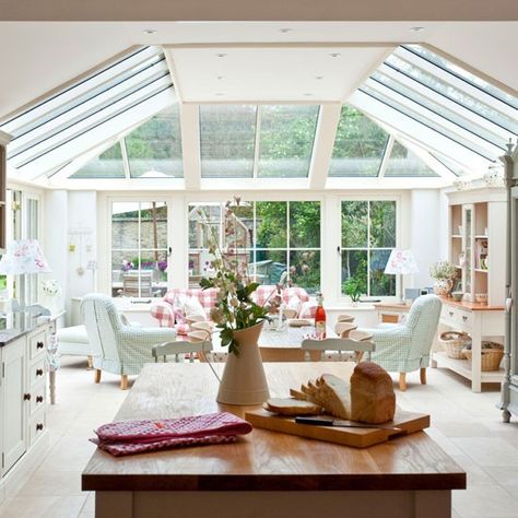 This open-plan conservatory kitchen-diner, is bathed in natural light by the floor-to-ceiling windows and the gingham chair covers and soft green and pink colour palette creates an English country feel. Conservatory Extension, Kitchen Conservatory, Conservatory Kitchen, Conservatory Design, Cotswold Cottage, Design Blogs, Kitchen Design Open, Kitchen Extension, Floor To Ceiling Windows