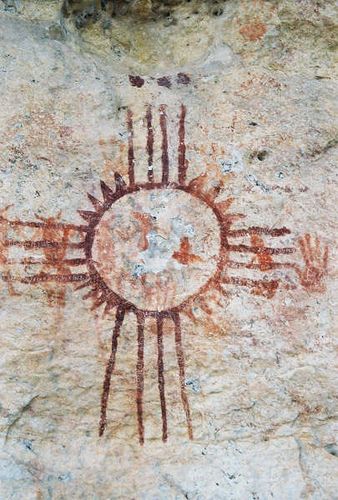 Zia photo by Roberto Botello.  Predating the New Mexico flag, this sun is a symbol of happiness that appears in the iconography of a number of Native American cultures - same historical period as is handprint to the right.  Members of the southern plains nations seem to have painted this over what appears to be prehistoric horned dancing figures. Ancient Native American Art, Ancient Sun Art, River Symbol Tattoo, Ancient Sun Symbol, Desert Symbols, Zia Symbol Tattoo, Sun Symbolism, Desert Culture, Sun Symbols