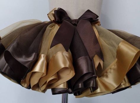 Brown and Gold tulle and ribbons. Tutu skirt. A beautiful gift for a little girl.  Birthday gift. Birthday party outfit. This is a brown and gold tutu skirt, made to order in any size.  Can be customized by the colors that you like. Good for Birthday parties, and celebrations. Baby girl tutu skirt.  Toddler girl outfit.  Brown tutu skirt.  Birthday outfit. My tutus are all made by sewing and ironing.  It has a perfect finish. This tutu skirt has brown and gold color tulle and ribbon.  They are a Gold Tutu, Gold Tulle, Girl Tutu Skirt, Toddler Tutu, Girl Tutu, Toddler Girl Outfit, Birthday Party Outfits