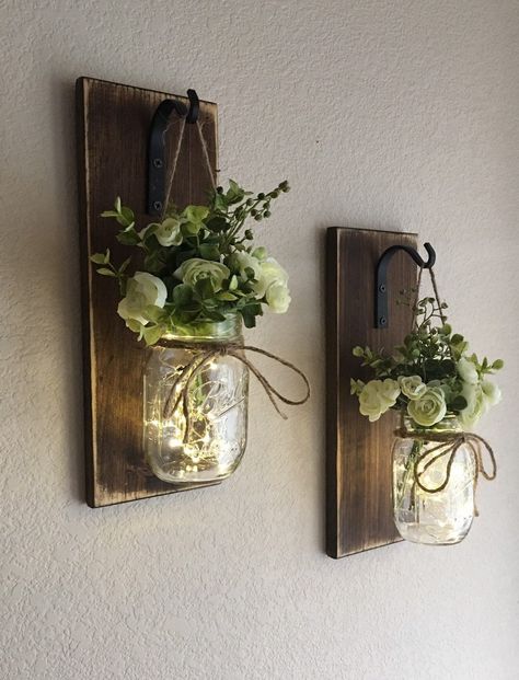 "FLOWERS and lights INCLUDED! This is a set of 2 or 3 gorgeous and perfectly rustic country mason jar wall sconces! They include a saw-tooth hanger for easy hanging and come in you choice of finish. Scroll through the listing to see all of your customization options.  {{Please leave a note at checkout with your flower color choices in the notes to seller box at checkout. The notes to seller box is located in your cart under the item you are purchasing.}} {{Sconce Finish Pictured is Distressed Wa Hanging Mason Jars, Jar Centerpieces, Rustic Mason Jars, Mason Jar Flowers, Jar Decor, Mason Jar Lighting, Decorated Jars, Mason Jar Diy, Mason Jar Crafts