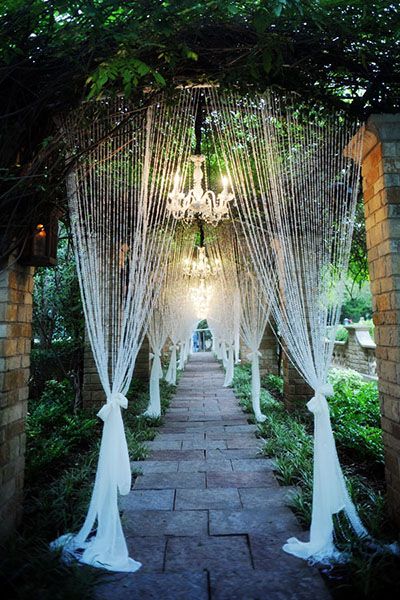 Personalize Your Wedding - Unique Wedding Ideas | Wedding Planning, Ideas & Etiquette | Bridal Guide Magazine Glass Decoration Wedding, Glass Door Wedding Decor, Wine Bottles With Lights Wedding, Outdoor Wedding Lanterns, Unique Wedding Ideas Creative, Fairy Light Tunnel Wedding, Wedding Tunnel Entrance Fairy Lights, Enchanted Decor, Lantern Centerpiece Wedding