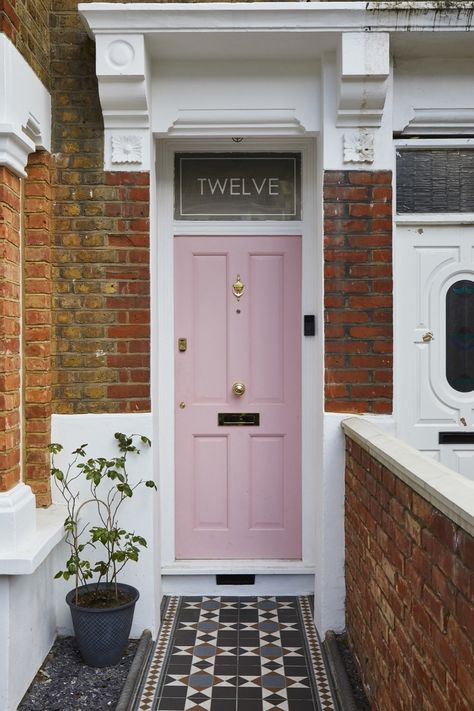 "We couldn't resist this beautiful shade of pink," notes Richard of the door color. "It was championed by Kristina, but I didn’t take much convincing. It would also draw a lot of attention and help the house to be easily found by visiting clients and potential new business." #dwell #london #modernhomerenovations Cork House, Victorian Front Doors, Pink Front Door, Victorian Terrace House, Rear Extension, Pink Door, London Property, Victorian Terrace, Front Door Colors