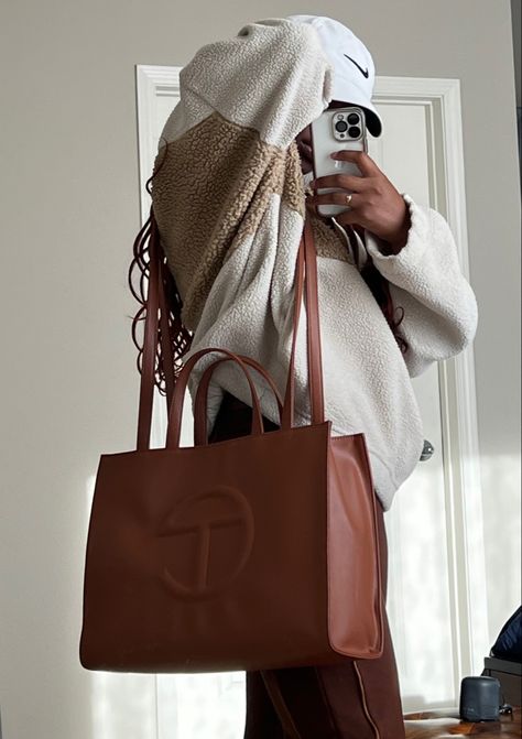 Black Girl wearing casual athletic clothes. Medium Tan Telfar Bag Outfit, Tan Telfar Bag Outfit, Medium Telfar Bag Outfit, Tan Sweatshirt Outfit, Tan Telfar Bag, Tan Bag Outfit, Telfar Bags Medium, Telfar Medium Bag, Telfar Bag Outfit