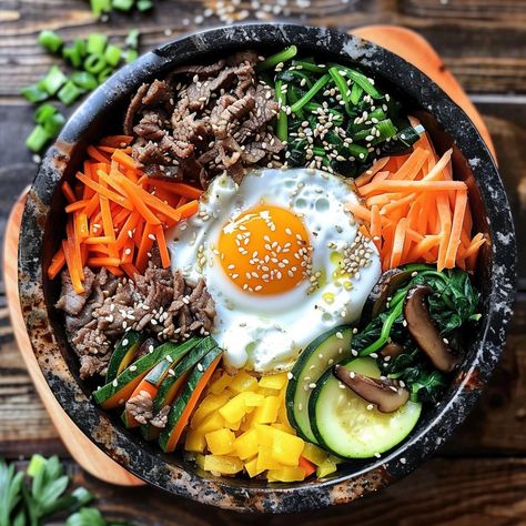 🍚 Enjoy the savory Bulgogi Dolsot Bibimbap! 🍲✨ #Bibimbap #KoreanCuisine Bulgogi Dolsot Bibimbap (Mixed Rice in a Hot Stone Pot) Ingredients: Bulgogi beef, sliced thinly (1/2 lb) Cooked rice (2 cups) Carrots, julienned (1 cup) Zucchini, julienned (1 cup) Spinach, blanched (1 cup) Bean sprouts, blanched (1 cup) Mushrooms, sliced (1 cup) Egg (1) Gochujang (Korean chili paste) (2 tbsp) Soy sauce (2 tbsp) Sesame oil (1 tbsp) Sesame seeds (1 tbsp) Vegetable oil (for cooking) Instructions: Marin... Banchan Korean Side Dishes, Korean Food Bibimbap, Bulgogi Bibimbap, Beef Bibimbap, Korean Meals, Dolsot Bibimbap, Korean Ingredients, Korean Bibimbap, Bibimbap Recipe