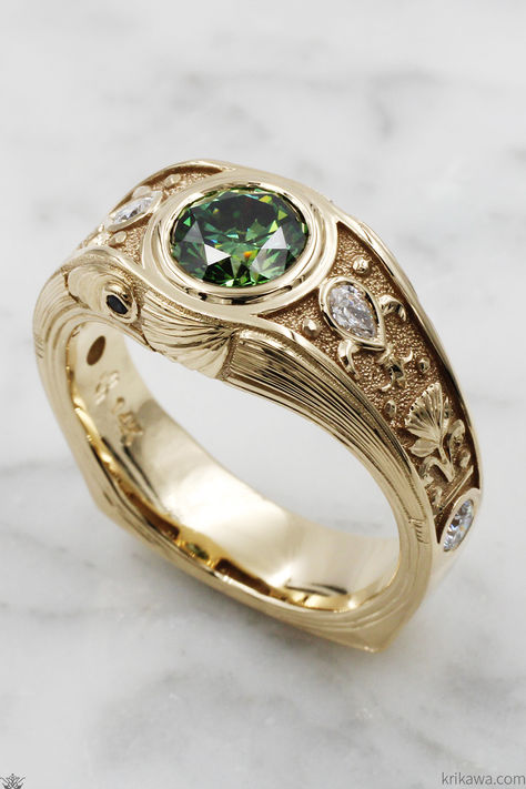 Elegance meets artistry in this unique Art Nouveau wedding band, made for the modern gentleman.  Have an idea for your dream ring but can't find it anywhere? Let's make it! This ring is not on our website as it is entirely custom.   Shown in 14k yellow gold, with a 1.34-carat green lab diamond and 0.33-carat lab diamond and natural sapphire accent stones.  #weddingring #weddingband #diamonds #artnouveau Masculine Engagement Rings, Art Nouveau Wedding Band, Masculine Wedding, Art Nouveau Wedding, Ring Symbolism, Nouveau Wedding, Art Nouveau Weddings, Queer Weddings, Custom Wedding Band