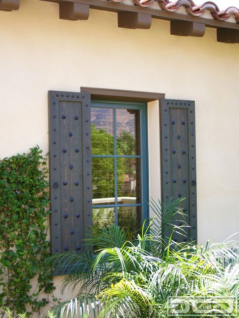 Customized Spanish shutters such as these come in a simple design but the rustic decorative ironwork that is used to embellish these shutters make these shutters a true Spanish architectural accent. Clavos of various sizes as well as diamond head shaped clavos give these shutters their touch of Spanish influence the beautifully stained cedar wood … Spanish Shutters, Mediterranean Shutters, Spanish Style Home Exterior, Stained Cedar, Modern Shutters, Shutter Ideas, Hacienda Homes, Tuscan Style Homes, House Shutters