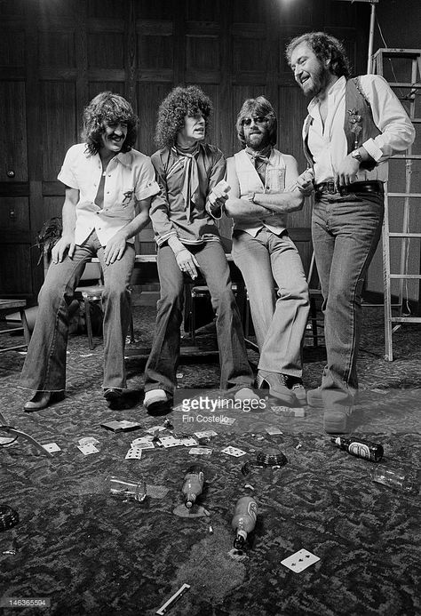 Scottish rock group Nazareth posed with playing cards and empty beer bottles in Vancouver, Canada in September 1976. Left to right: Manny Charlton, Dan McCafferty, Darrell Sweet and Pete Agnew. Nazareth Band, Fad Fashion, Beer Bottles, Rock Groups, Rock Posters, Vancouver Canada, Rock Music, Hard Rock, High Res