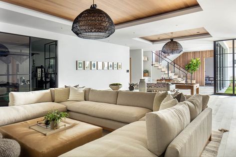 Coastal contemporary home celebrates indoor-outdoor living in California U Shaped Sectional Living Room, Coastal Basement, Sectional Living Room Layout, Leather Ottoman Coffee Table, Brooke Wagner Design, Brown Leather Ottoman, Brooke Wagner, Sectional Living Room, Open Living Room Design