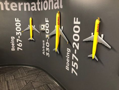 DHL Airplanes Flying Off the Walls of their Corporate Offices in Miami, Florida! Small Office Design Interior, Small Office Design, Corporate Offices, Interactive Museum, Interactive Exhibition, Office Interior Design Modern, Airport Lounge, Air India, Office Branding