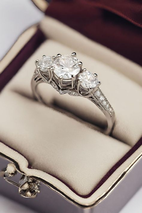 Securing the second spot among our 21 Three Stone Engagement Rings is this enchanting Vintage Cathedral Setting Three Stone Diamond ring. Its timeless design, reminiscent of a bygone era, features a majestic cathedral setting that accentuates the beauty of the three sparkling diamonds. Embark on a journey through our curated collection by clicking to see more. Three Stone Engagement Rings Vintage, Pretty Engagement Rings, Cathedral Engagement Rings, Three Stone Diamond Rings Engagement, Cathedral Setting, Stone Diamond Ring, Three Stone Diamond Ring, Three Stone Diamond, Cushion Diamond