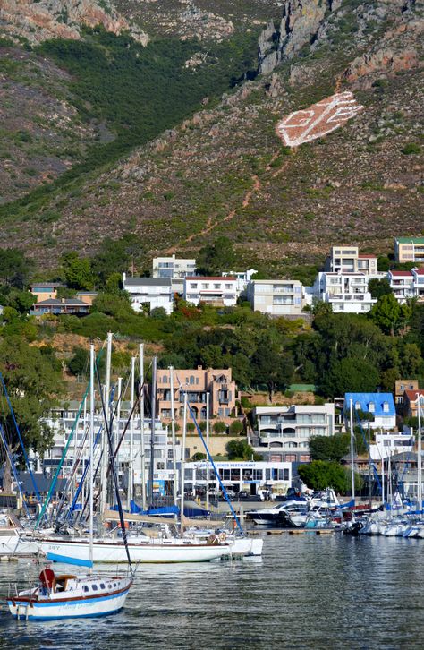 The well-known Gordons Bay sign against the Hottentots-Holland mountain behind the town. The old harbour and the yacht club is visible in the front. #GordonsBay #yachtclub Somerset West, Travel Africa, Harbour Island, Historical Buildings, Holiday Places, Table Mountain, Cape Town South Africa, Western Cape, Luxury Accommodation