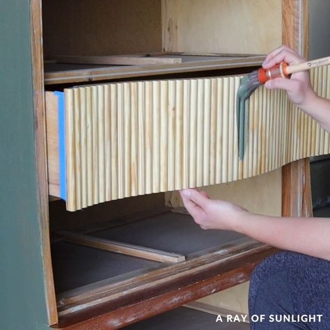 DIY Fluted Dresser Makeover | art, Makeover, paint | Check out this DIY Fluted Dresser makeover with a thrifted Art Deco style dresser, paint, and some wooden half dowels to give a fresh and modern look. | By A Ray of Sunlight - Painted Furniture & DIY | Hey, guys. This week, I did something I've been wanting to do for a while now and I can't wait to show you what I did. Here's the piece that I started out with. It's an art deco-style dresser with a really sad paint job that was scratching off i Dowel Rod Dresser, Wood Dowel Dresser, Adding Dowels To Furniture, Half Painted Dresser, Half Dowel Furniture, Rounded Dresser Makeover, Wooden Dowel Dresser Diy, Painted Tall Dresser, Boho Dresser Flip