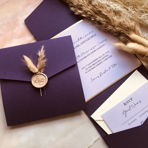 Personalised Wedding invitations with beautiful purple matte pocketfolds, wax seals, bunny tails and dried flowers! The elegant design is paired with white shimmer envelope. Format: Pocket Fold, Shape: Square, Colour: Purple pocket and white shimmer envelopeChoosing 'Say It With Print' will mean your laser cut invitation pockets and envelopes will arrive in style in a beautiful white presentation box.Items included: Purple Pocket, Gold Mirror Backer, Lilac Insert Cards, Gold Initials Wax Seal, B Bunny Tails Wedding, Gold Wedding Invitations Elegant, Plum Wedding Invitations, Envelope Format, Witch Store, Purple And Gold Wedding, Purple Invitations, Purple Envelope, Dried Flowers Wedding