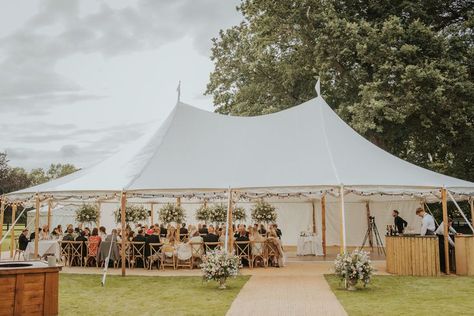 This medium sailcloth tent has a mix of white and clear sides, with the clear sides rolled up to make the most of the weather. Other finishing touches from Events Under Canvas, matted walkway, fire pit, circular bar, cross back chairs rustin tables and dance floor. Events Under Canvas We've got spectacular covered Events Under Canvas, Decorate Tent For Wedding, Sailcloth Wedding Tent, Canvas Tent Wedding, Beach Tent Wedding, Sailcloth Tent Wedding, Tent Flooring, Tent Entrance, Circular Bar