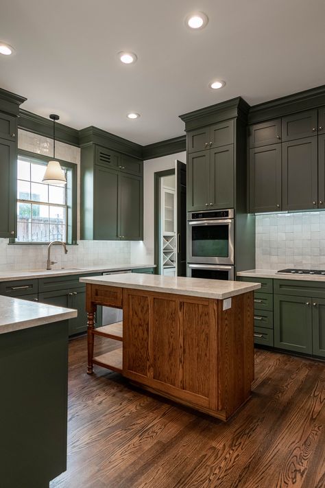 We are so proud of this West University Houston remodel! This moody green kitchen is so dreamy! interior design, kitchen remodel, houston interiors, houston remodel, green kitchen Green Kitchen Cabinets With Dark Wood Floors, Moody Green Kitchen, Dual Tone Kitchen Cabinets, Earth Tones Kitchen, Olive Green Kitchen, Green Cabin, Walnut Kitchen Cabinets, Kitchen Soffit, Sage Kitchen