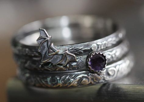 I made this set of 3 intricately patterned  solid sterling silver patterned rings with a sweet little vampire bat, also sterling.  I added a beautiful little genuine 4mm amethyst encased in a serrated sterling bezel.  Widths of bands vary from 2.4mm-3.5mm. SIZING HINT:  I'd advise ordering 1/2 size up for this or any multiple ring stack if you want to wear them all together.  It's much more comfortable to wear. The sterling silver has been darkened/antiqued then polished to bring out the pattern Little Vampire, Bat Ring, Vampire Bat, Stacking Ring Set, Gothic Rings, Celestial Jewelry, Pretty Jewelry, Gothic Jewelry, Jewelry Inspo