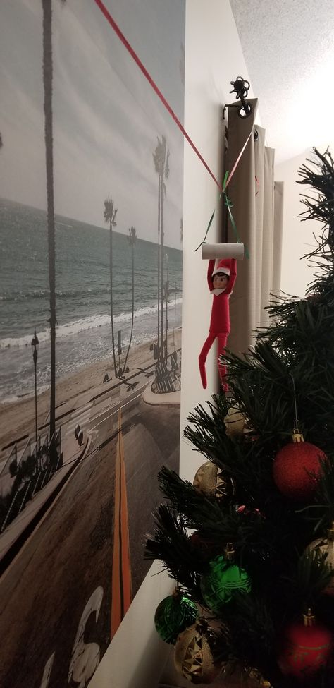 Elf On Shelf Ziplining, Zipline Elf On The Shelf, Elf Hanging From Ceiling, Elf Swinging From Ceiling Fan, Elf On The Shelf Ideas Zipline, Swinging Elf On The Shelf, Elf On The Shelf Hanging From Fan, Elf On The Shelf Swing Diy, Elf Zipline Ideas