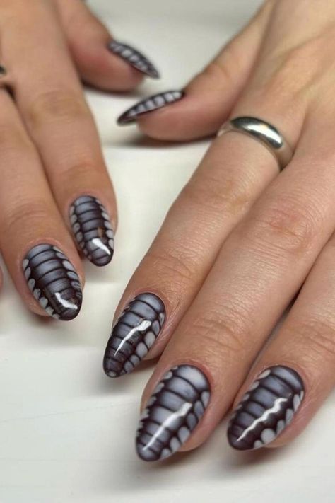 These almond-shaped nails feature a striking crocodile design. The intricate pattern includes scaled textures in shades of dark grey and black, mimicking the look of reptilian skin. The high-gloss finish adds a captivating shine, enhancing the realistic appearance of the crocodile-inspired nail art. Elegant and bold!  // Photo Credit: Instagram @envoguenailsofficial Winter Nails Short Acrylic, Chrome Crocodile Nails, Tips Nails Acrylic, Simple Nails Winter, Crocodile Nails, Snake Skin Nails, Sophisticated Manicure, Es Nails, Oval Shaped Nails