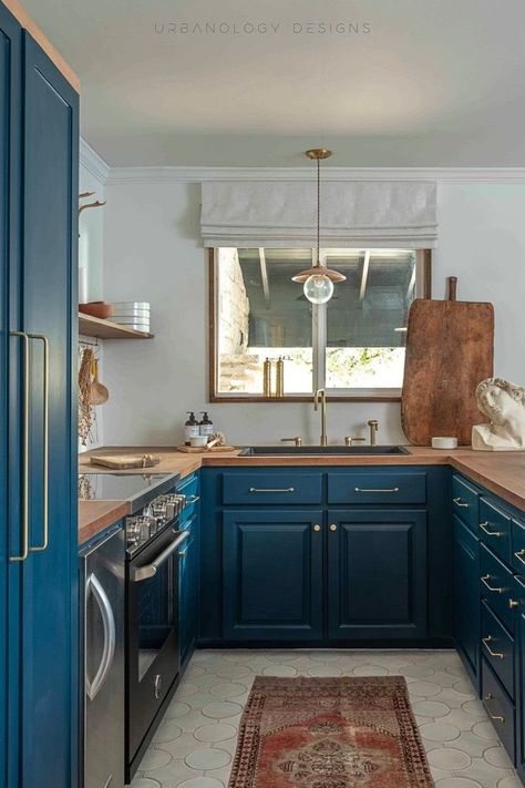 Relax in this guest cottage kitchen, complete with beautiful blue kitchen cabinets and wood countertops. Open Shelving provides function and style, and the kitchen is open concept to the dining and living room area. See the whole interior design project at Urbanology Designs. Cabinets Butcher Block Countertops, Modern Cottage Interior Design, Urbanology Designs, Dark Blue Kitchen Cabinets, Modern Cottage Interior, Dark Blue Kitchen, Butcher Block Countertops Kitchen, Flair Design, Dark Blue Kitchens