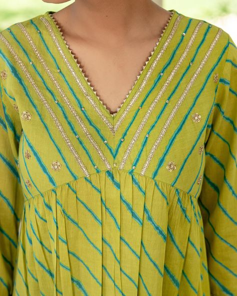 ~HARMONY OF HUES~ Lehariya Collection - New Arrivals! A fresh vibrant look with teal Lehariya contrasting against a lime green base. Rows of silver gota enhance the elegant neckline and sleeve cuffs. This is a standout piece for festive occasions. [ Cottons Jaipur, Cotton, Lehariya, Rajasthan, Handcrafted, Traditional, Ethnic] #cottons #cottonsjaipur #newarrivals #rajasthan #heritage #traditional #lehariya #lehariyasuits #kurta #craftmanship #indianart #colours #indian #ethnic #cottonkur... Cotton Lehriya Kurti Designs Latest, Lehriya Kurti Designs Latest, Lehriya Kurti Designs, Lehariya Kurti Designs, Leheriya Kurti, Cottons Jaipur, Cotton Dress Pattern, Neck Patterns, Kurti Cotton