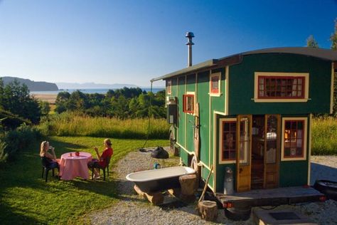 Love this funky little green housetruck in Golden Bay, New Zealand, overlooking a bay. | Tiny Homes Painted Exterior House, Giant Bathtub, Remodeled House, House Truck, Yellow Window, Truck House, Tiny House Swoon, Tiny House Exterior, Outdoor Tub