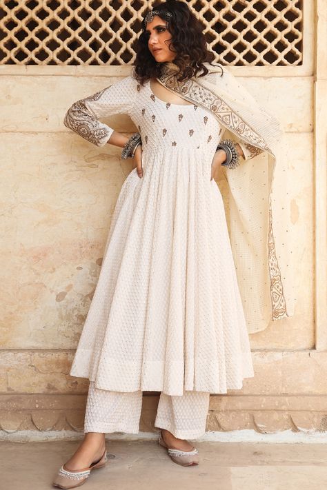 Featuring a white anarkali in cotton and doriya base with machine embroidery. It is paired with matching pants and an embroidered dupatta. NOTE: If you happen to see some deformity in hand-work or fabric, that?s merely the technique of the same and not a defect.  FIT: Fitted at bust and waist. COMPOSITION: Cotton, Doriya. CARE: Dry clean only. Gulabo Jaipur, Off White Anarkali, White Anarkali, Cotton Anarkali, Embroidered Anarkali, Embroidered Pants, New Address, Embroidered Dupatta, Indian Fashion Designers