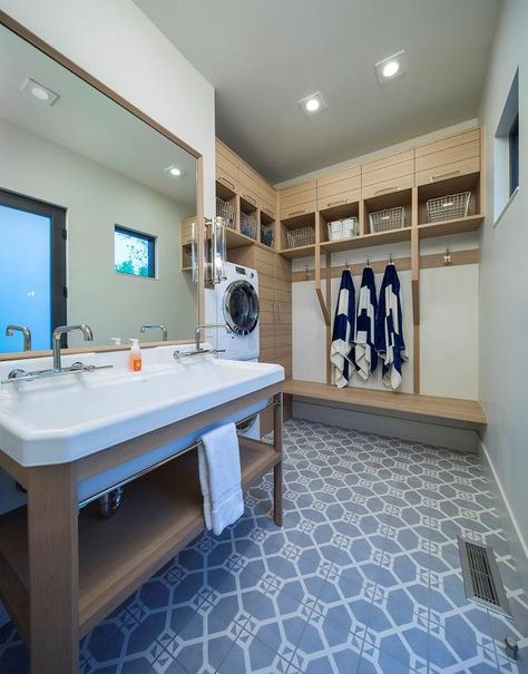 Beautiful laundry room and pool room combo is clad in gray and white octagon floor tiles framing a blond dual washstand sat beneath a blond framed vanity mirror mounted to white walls illuminated by a nickel and glass sconce. Mud Room Laundry Room Combo, Cottage Laundry, Washer Dryer Laundry Room, Cottage Laundry Room, Pool House Bathroom, Craftsman Kitchens, Custom Laundry Room, Laundry Room/mud Room, Laundry Room Lighting