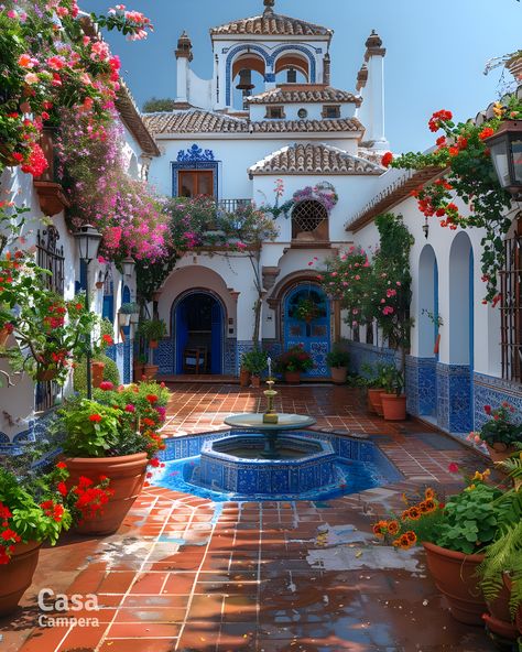 Step into elegance with this Spanish patio showcasing a beautiful mosaic fountain and lush greenery. The intricate tile work and blooming flowers create a picturesque setting. Follow CasaCampera for inspiring patio designs! Outdoor Spanish Tile, Spanish Patio Ideas, Spanish Garden Ideas, Spanish Style Patio, Spanish Backyard, Spanish Style Courtyard, Spanish Gardens, Mexican Courtyard, Spanish Patio