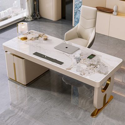 Introducing the ultimate blend of elegance and durability — our Sintered Stone Desk. The desktop is crafted from sintered stone, a material renowned for its exceptional scratch and wear resistance, ensuring your desk will retain its pristine appearance for years. The high hardness of sintered stone also guarantees superior durability and longevity. The frame of this desk is constructed from stainless steel with a luxurious gold finish, adding a touch of elegance to any workspace. The real wood d Luxurious Desk, Luxury Office Desk, Luxury Beige Office Sets, White Gold Desk Office, White Desk Gold, Luxury Marble Desk, Whote And Gold Desk, Luxury Desk, Steel Desk