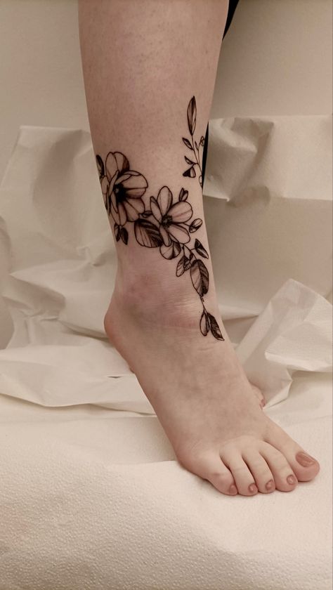 ankle tattoo based on flowers and nature. in this photo you only see part of the ankle Ankle Leaves Tattoo, Large Ankle Tattoo, Ankle Floral Tattoo, Floral Tattoo Coverup, Front Ankle Tattoo, Floral Ankle Tattoo, Front Ankle Tattoos, Wrap Around Ankle Tattoos, Tattoos Ankle