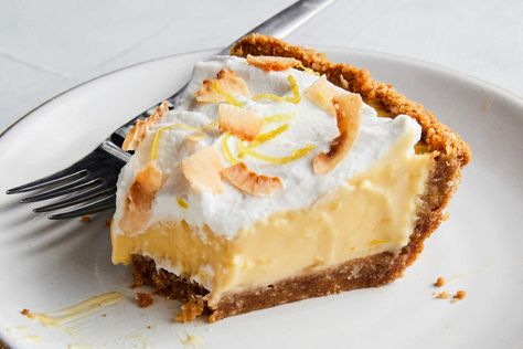 This creamy, dreamy lemon pie is packed with lots of bright zesty lemon flavor and coconut four ways The classic graham cracker crust is enhanced with a handful of toasted coconut, the filling is rich with coconut milk and the whipped coconut cream topping is garnished with more crunchy, toasted coconut This pie is a dinner party dream: You can make it up to two days in advance and it just gets better sitting in the fridge Creamy Coconut Lemon Pie, Desserts Fourth Of July, August Recipes, Coconut Treats, Whipped Coconut Cream, Lemon Pie Recipe, Sweet Pies, Coconut Pie, Lemon Yogurt