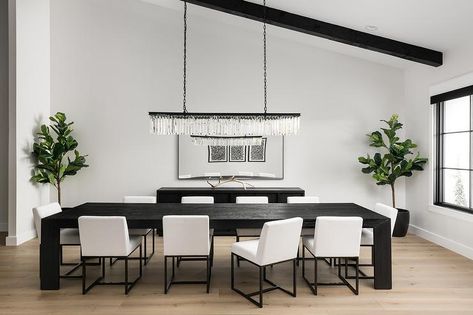 Restoration Hardware 1920s Odeon Clear Glass Fringe Rectangular Chandelier hanging above a Restoration Hardware Arles Rectangular Dining Table fitted with a set of Restoration Hardware Emery Fabric Side Chairs in a transitional dining space designed with a black and white theme. Conference Table To Dining Table, Restoration Hardware Dining Table, Restoration Hardware Dining Room, Minimal Dining Room, Black Dining Room Table, Black And White Dining Room, Minimal Dining, Restoration Hardware Dining, Low Back Dining Chairs